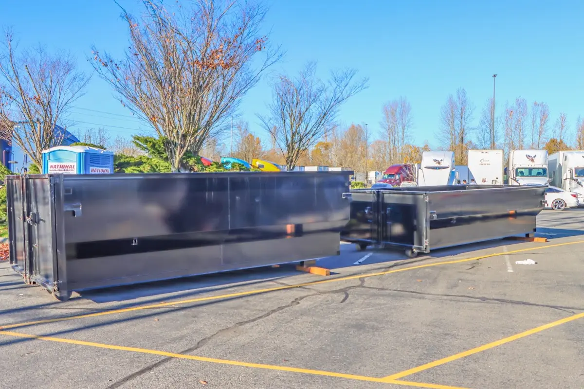 Professional dumpster rental service with roll-off container on residential driveway in German Flatts